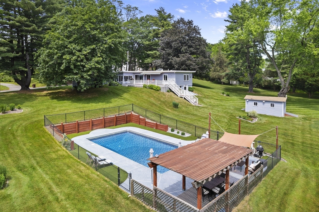 44 Locust Street Merrimac, MA 01860 - Photo 1 of 42 a view of a swimming pool with a patio