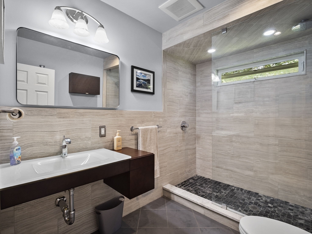 44 Locust Street Merrimac, MA 01860 - Photo 25 of 42 a bathroom with a sink and a mirror