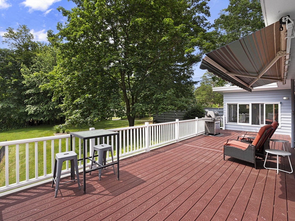 44 Locust Street Merrimac, MA 01860 - Photo 26 of 42 a view of a chair and table on the wooden deck