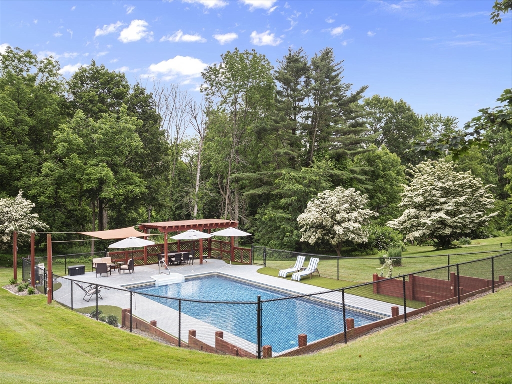 44 Locust Street Merrimac, MA 01860 - Photo 30 of 42 a view of a swimming pool with an outdoor seating and a yard