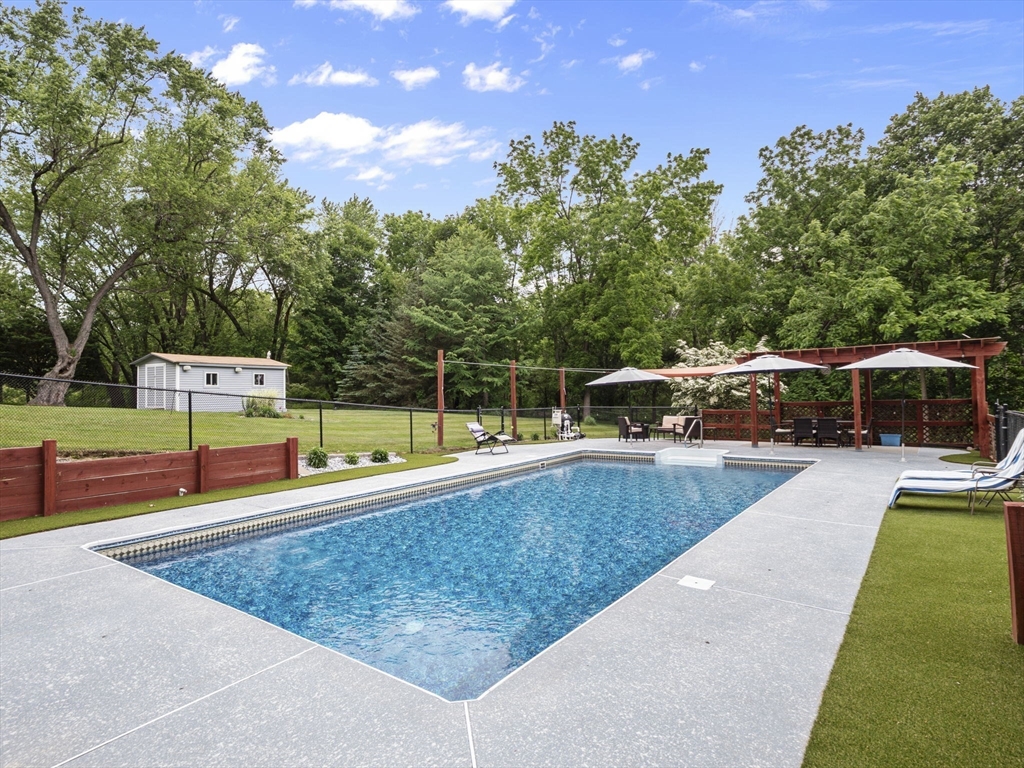 44 Locust Street Merrimac, MA 01860 - Photo 31 of 42 a view of a swimming pool with a bench and trees