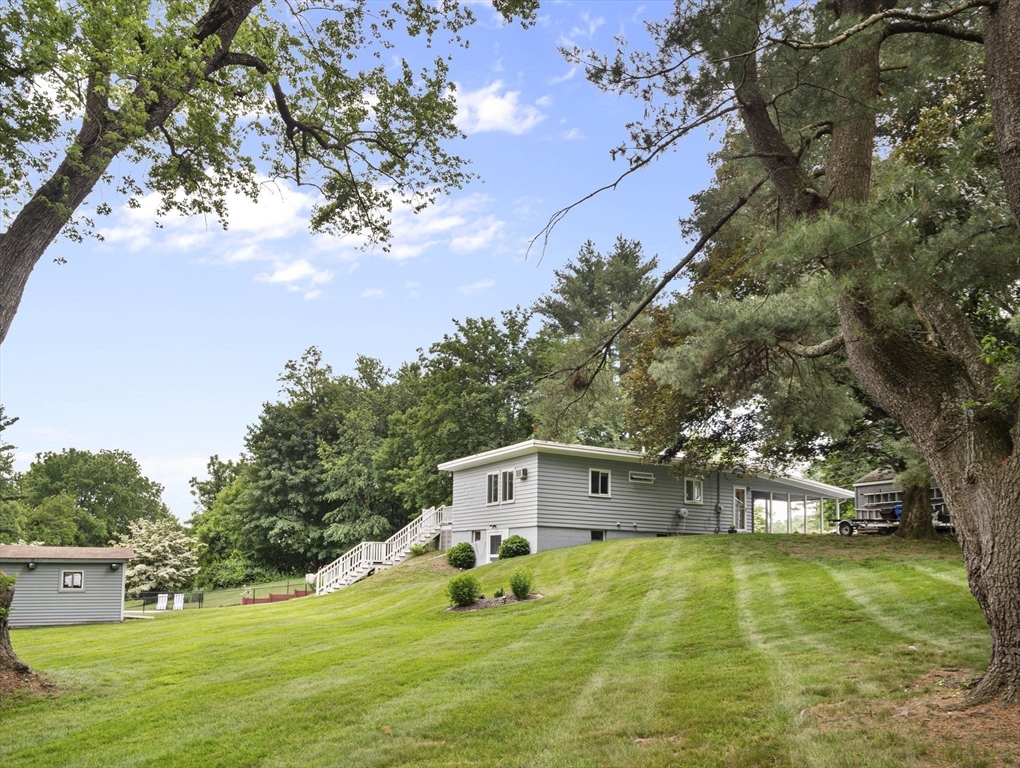 44 Locust Street Merrimac, MA 01860 - Photo 36 of 42 a house with trees in the background