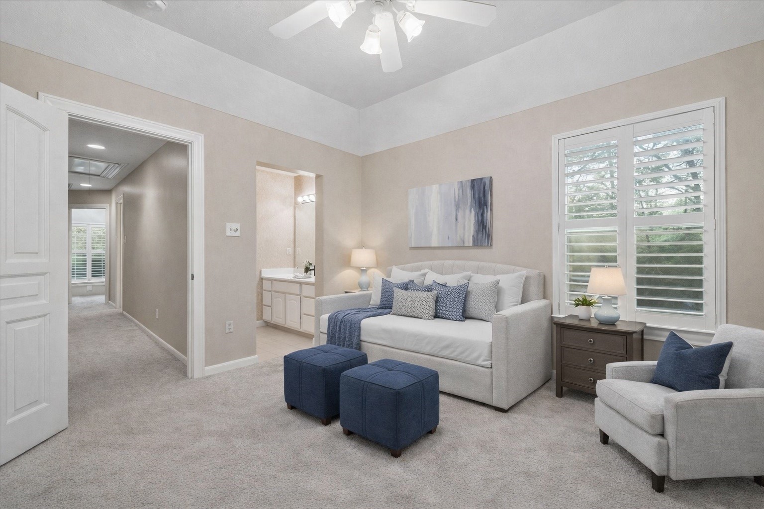 14530 Millhouse Road Pinehurst, TX 77362 - Photo 29 of 46 VIRTUALLY STAGED - Additional upstairs bedroom with tray ceiling, plantation shutters, and direct access to a private vanity area within the shared bath.