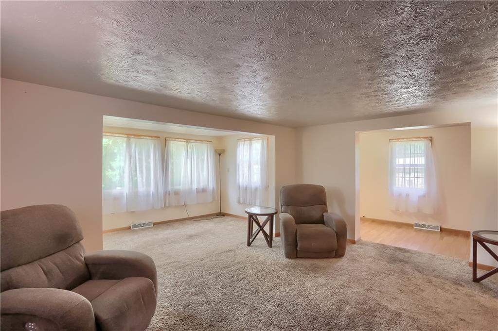 1261 Highway 989 Rochester, PA 15074 - Photo 12 of 25 Huge living room with a side room which would be great for a small office or to keep the toy box out of the way!!. Notice all of the natural light with all of the windows.