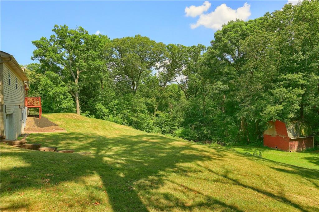 1261 Highway 989 Rochester, PA 15074 - Photo 24 of 25 Large 1 acre lot with lots of room to play. extra 1.5 garage in rear of the home for all of you ATVs lawn equipment and more storage.