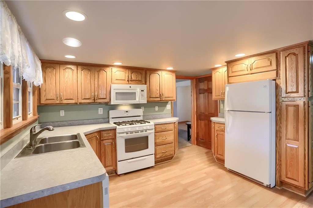 1261 Highway 989 Rochester, PA 15074 - Photo 7 of 25 Beautiful oak cabinets with gas stove oak trim on windows and another pantry.