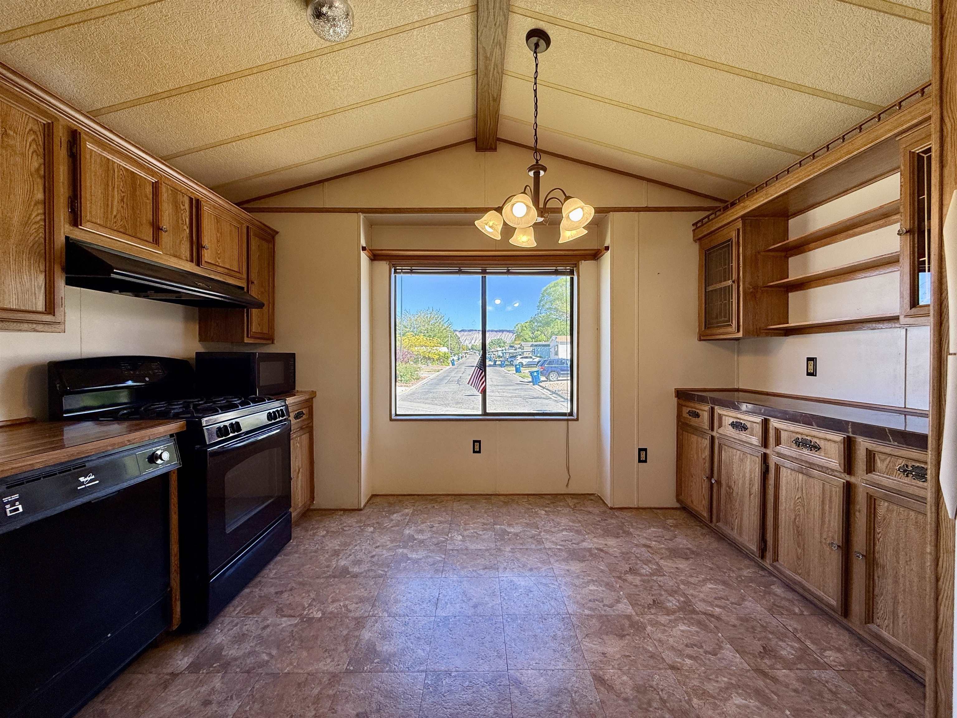 3251 E Road, Unit 33 Clifton, CO 81520 - Photo 11 of 28 a kitchen with stainless steel appliances granite countertop a stove and a refrigerator