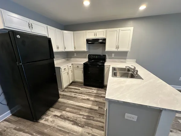 a kitchen with a refrigerator stove and sink