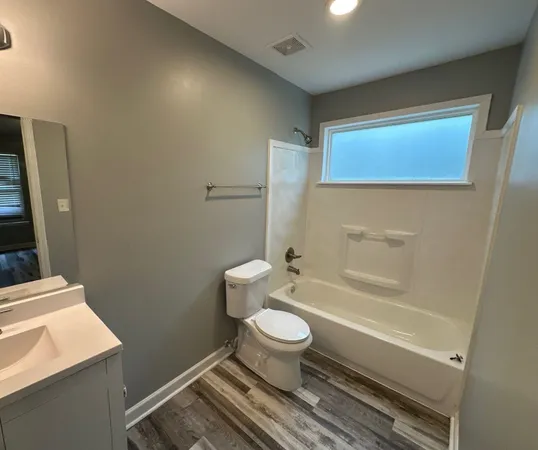 a bathroom with a toilet a sink and bathtub