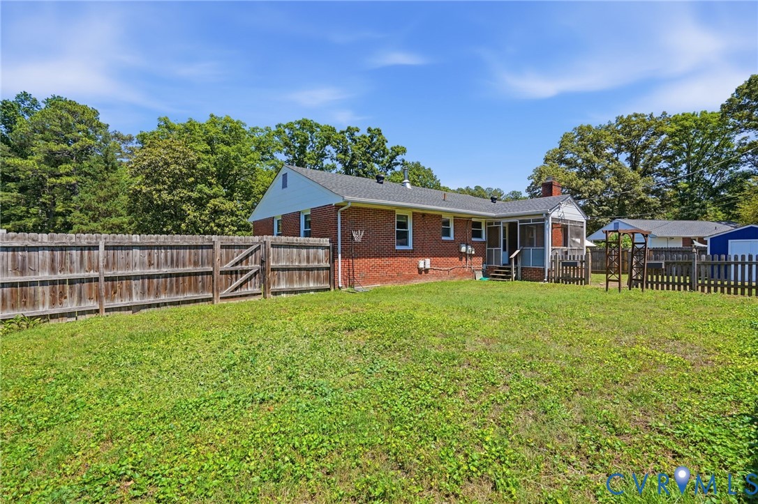2403 Omega Road Henrico, VA 23228 - Photo 33 of 39 a view of a house with a backyard and a patio