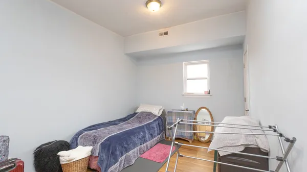 a room with a bed and a dresser