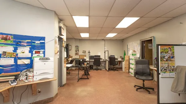 a view of a livingroom with workspace and a couch