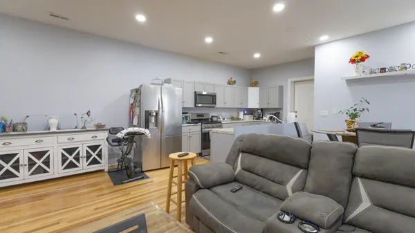 a living room with furniture and a wooden floor