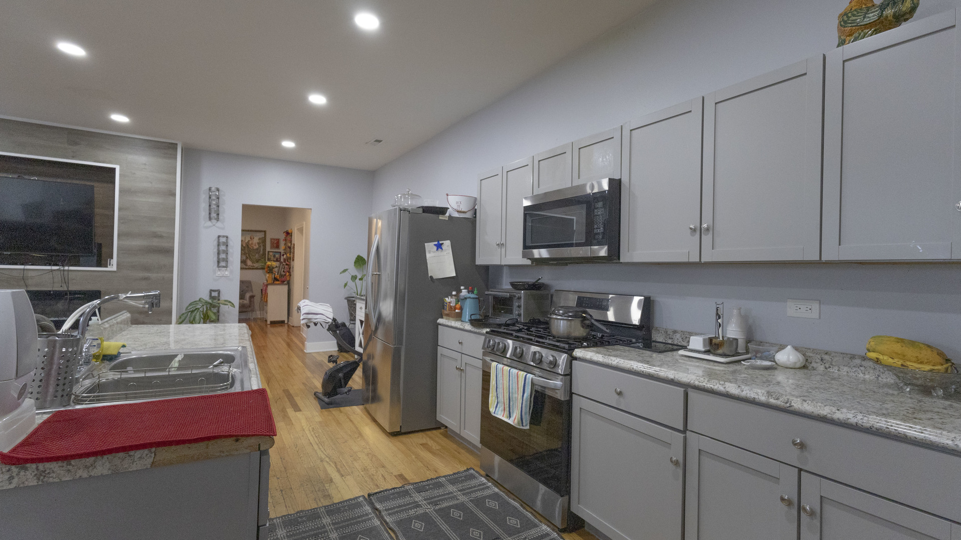 3612 West Roosevelt Road Chicago, IL 60624 - Photo 7 of 32 a kitchen with stainless steel appliances granite countertop a stove top oven a sink dishwasher a refrigerator and a microwave