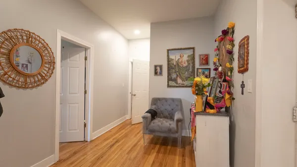 a living room with furniture and a wooden floor