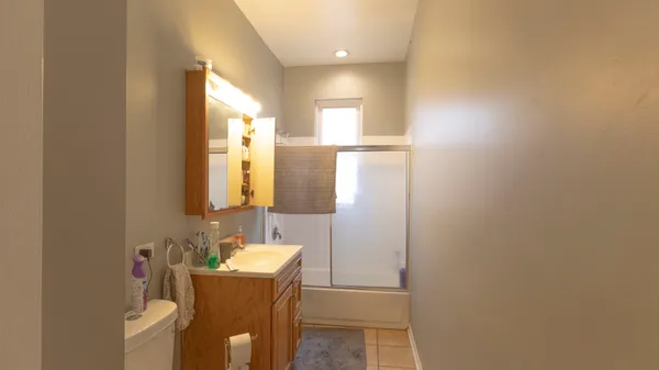 a bathroom with a sink a mirror and a bathtub