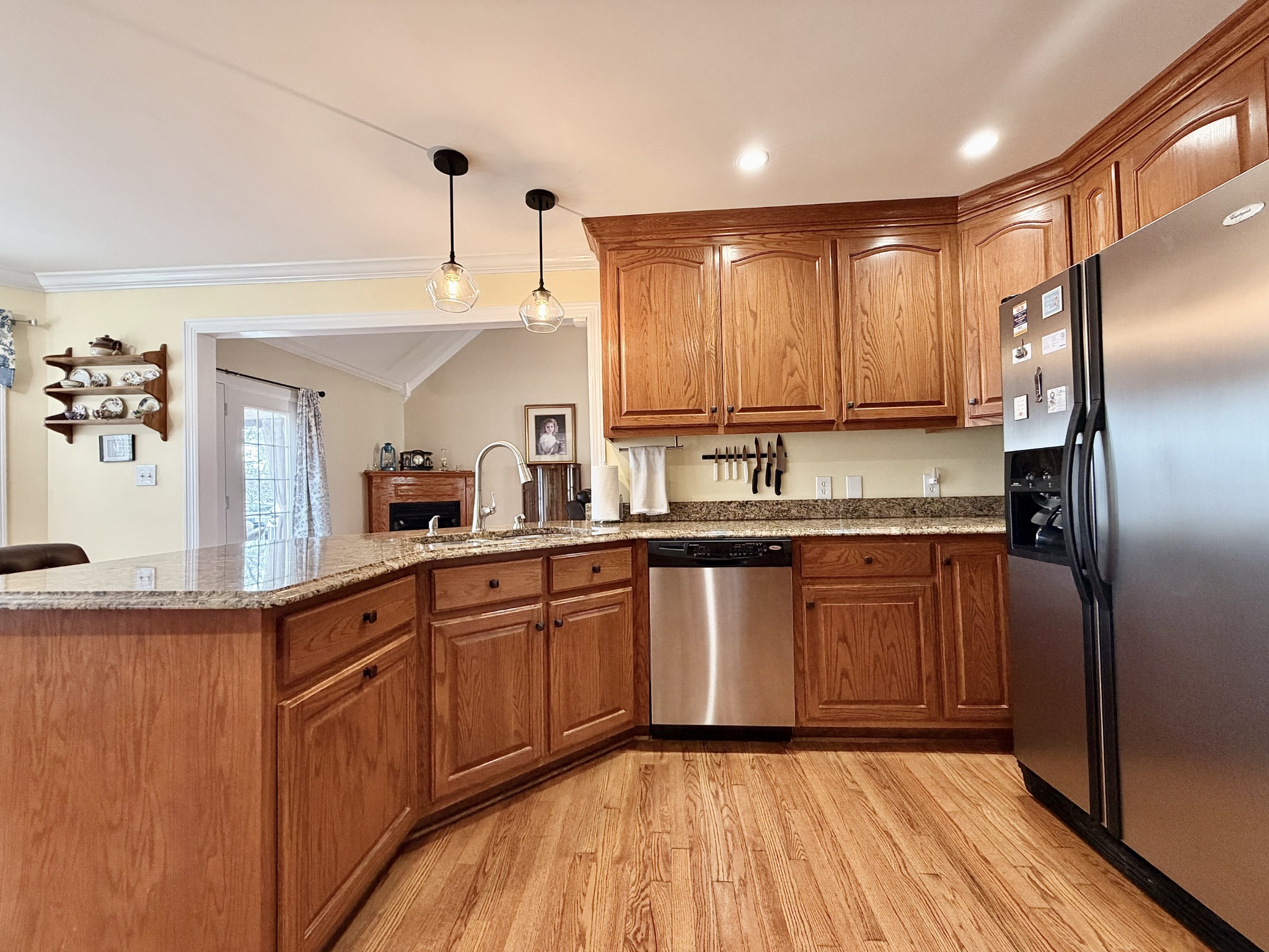 101 Mimi Circle Pulaski, TN 38478 - Photo 14 of 56 a kitchen with stainless steel appliances granite countertop a refrigerator a sink dishwasher a stove with wooden cabinets and floor