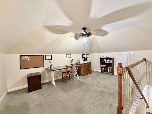 a view of a livingroom with furniture and a ceiling fan