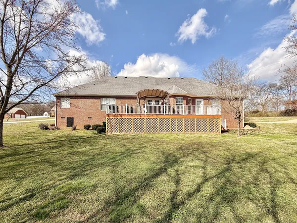 a front view of a house with a big yard