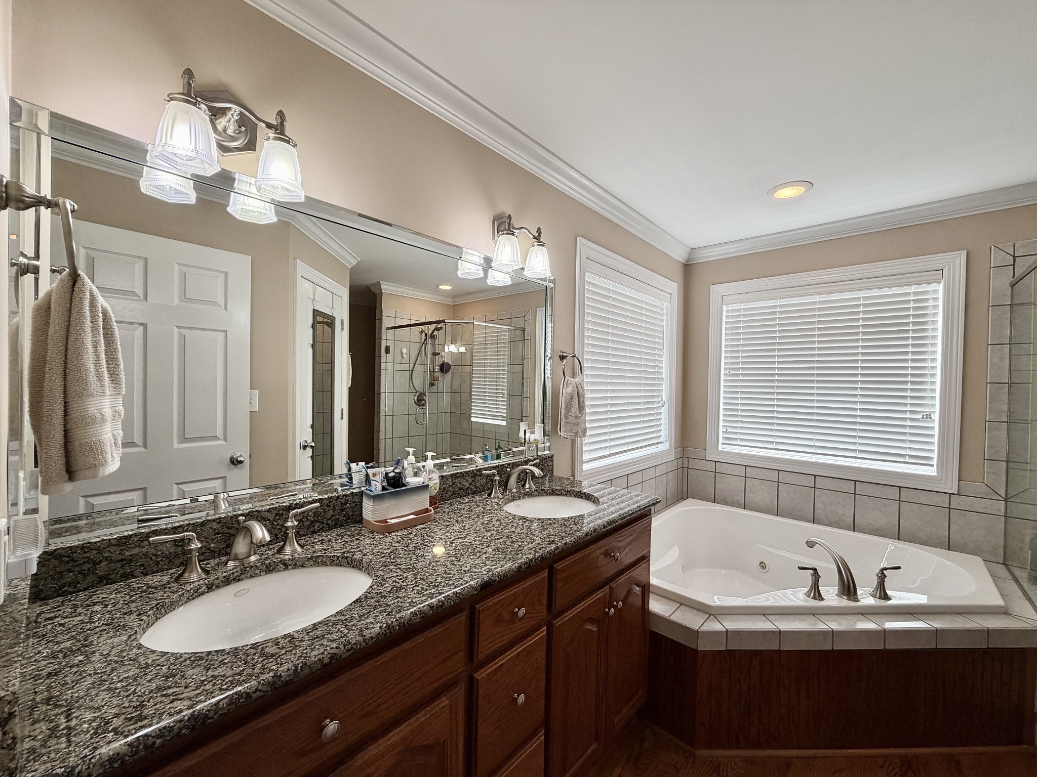 101 Mimi Circle Pulaski, TN 38478 - Photo 40 of 56 a bathroom with a granite countertop tub a double vanity sink and a large mirror