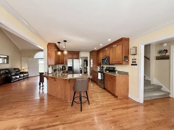 a kitchen with counter top space cabinets and wooden floor