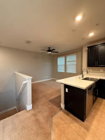 a modern kitchen with refrigerator and microwave