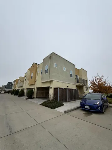 a front view of a house with a parking space