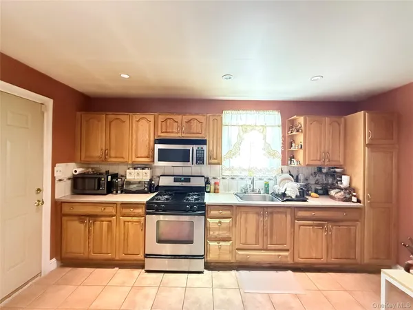 a kitchen with a stove a sink and a microwave