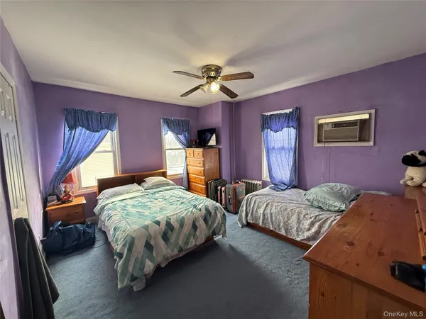 a bedroom with bed and a chandelier