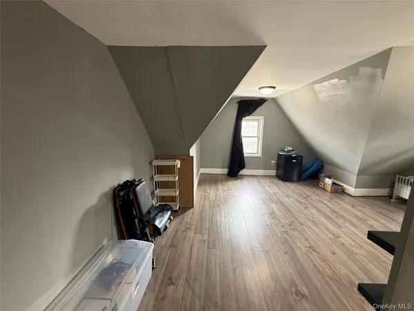 a hallway with couches and wooden floor