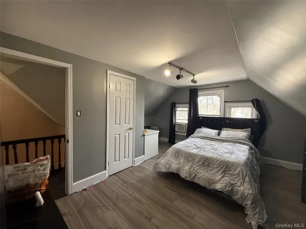 a bedroom with a bed and window
