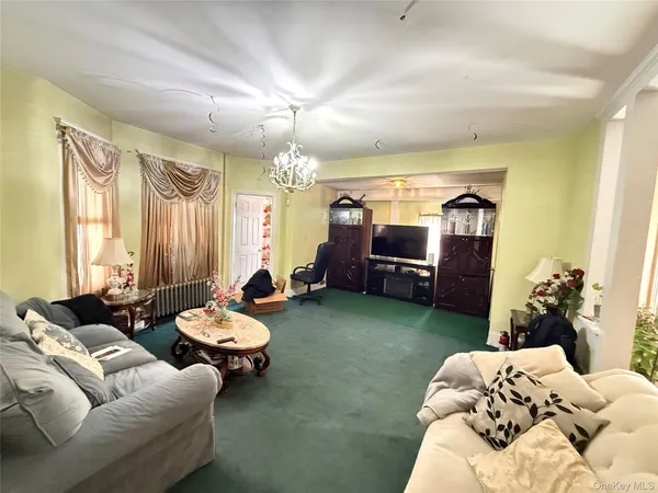 a living room with furniture and a chandelier
