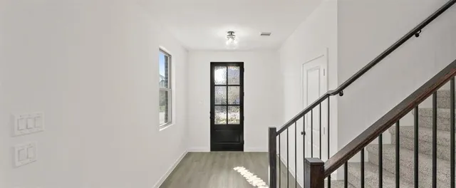 a view of an entryway with wooden floor