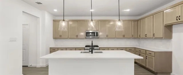 a kitchen with a sink a counter space and cabinets