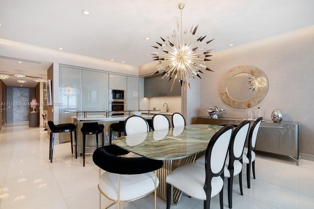 a dining room with furniture and chandelier
