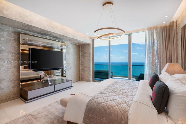 a bedroom with a bed and glass window