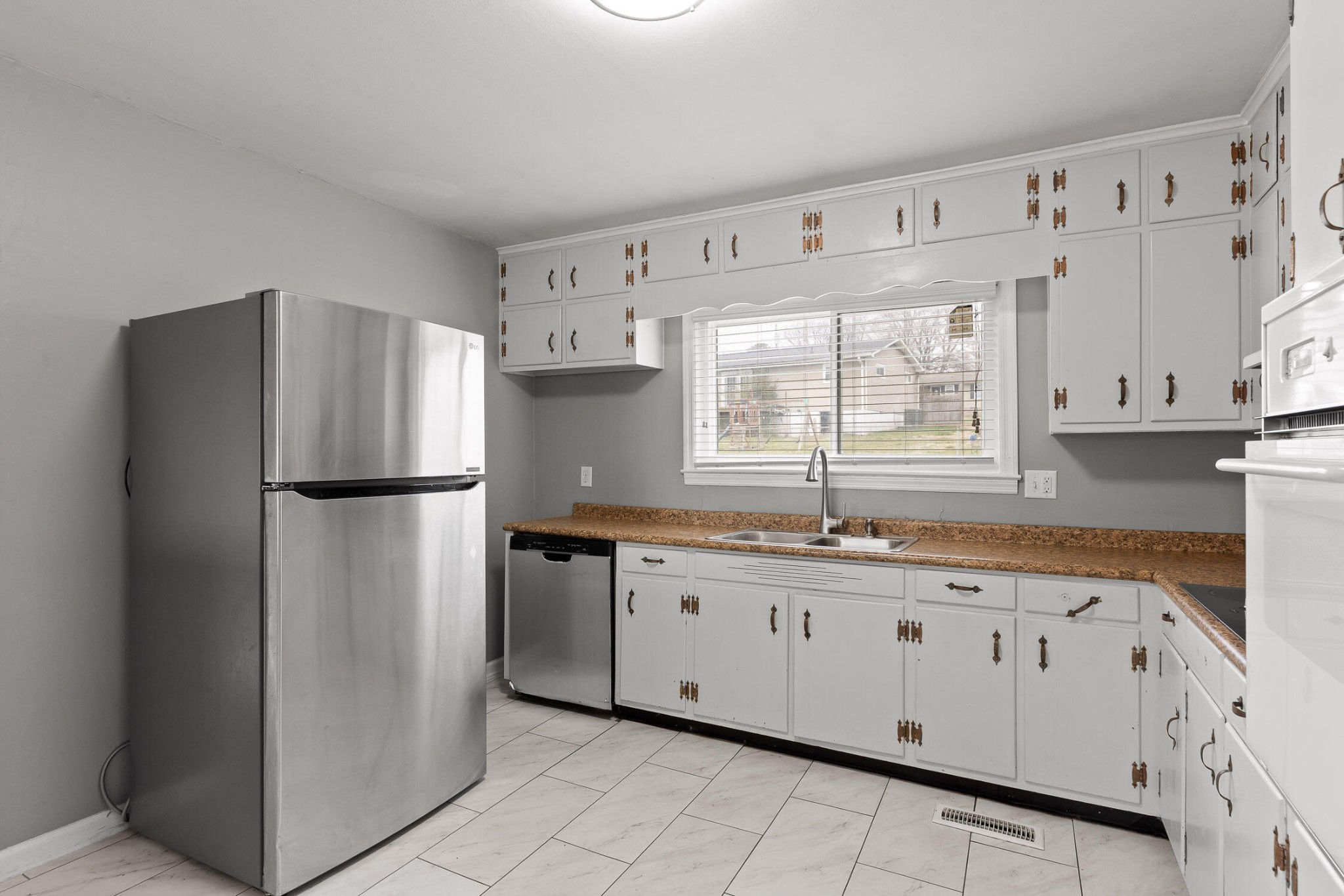 45 Virginia Avenue Rossville, GA 30741 - Photo 12 of 28 a kitchen with granite countertop white cabinets and refrigerator