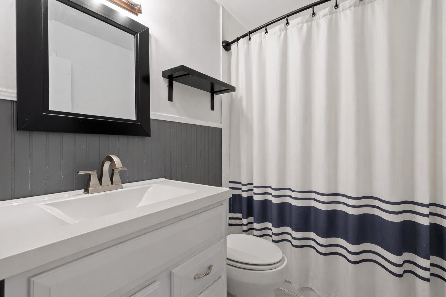 45 Virginia Avenue Rossville, GA 30741 - Photo 21 of 28 a bathroom with a sink a mirror and a toilet