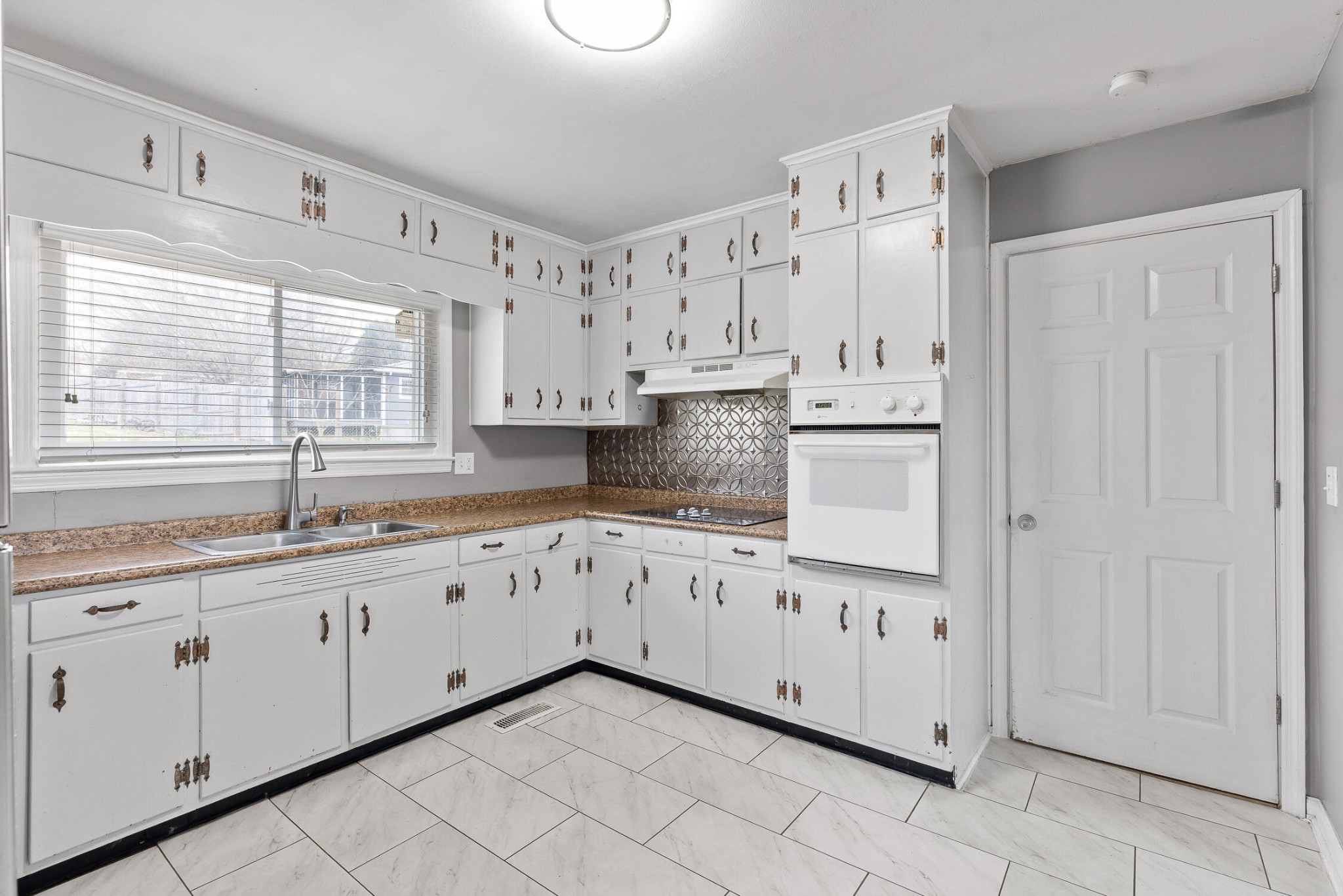45 Virginia Avenue Rossville, GA 30741 - Photo 8 of 28 a kitchen with granite countertop white cabinets white appliances with a sink and dishwasher