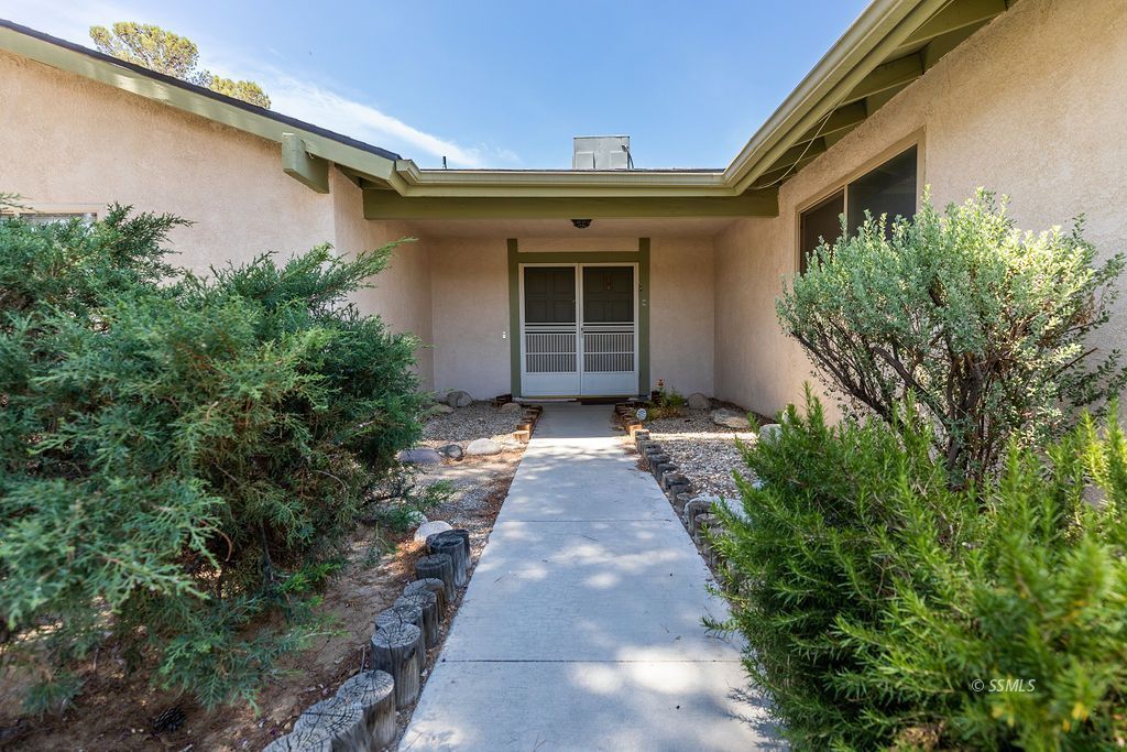 831 Peg Street Ridgecrest, CA 93555 - Photo 3 of 32 a view of a house with a yard