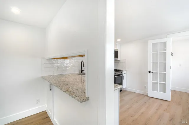 an empty room with windows and closet