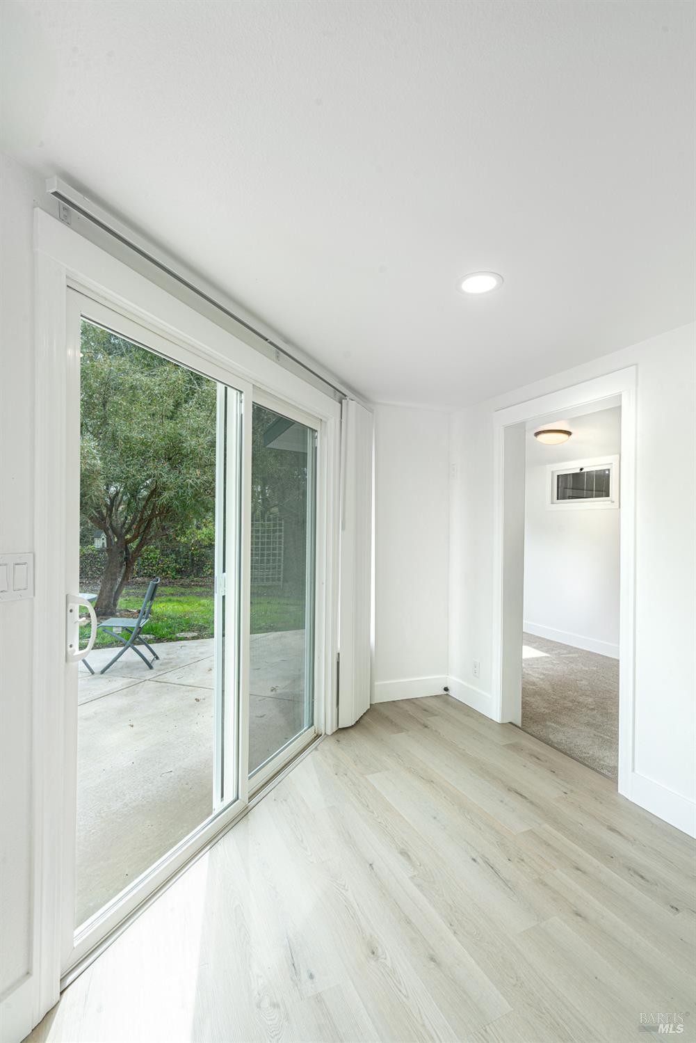 810 Brush Creek Road, Unit B Santa Rosa, CA 95404 - Photo 17 of 25 an empty room with wooden floor and windows