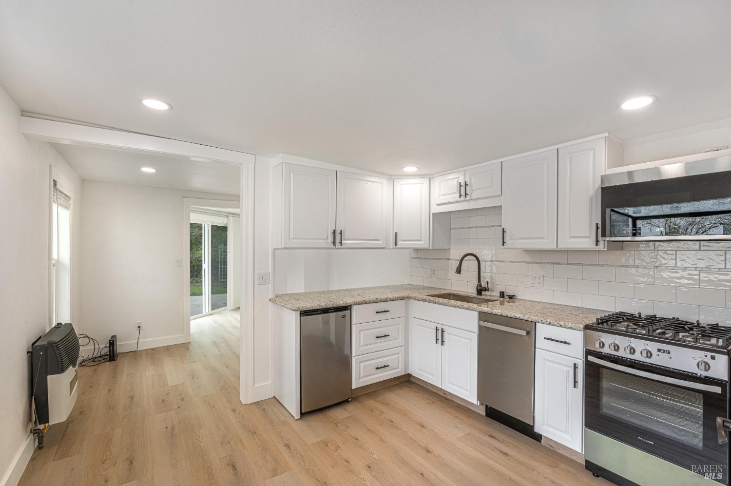 810 Brush Creek Road, Unit B Santa Rosa, CA 95404 - Photo 9 of 25 a kitchen with a sink stove and cabinets