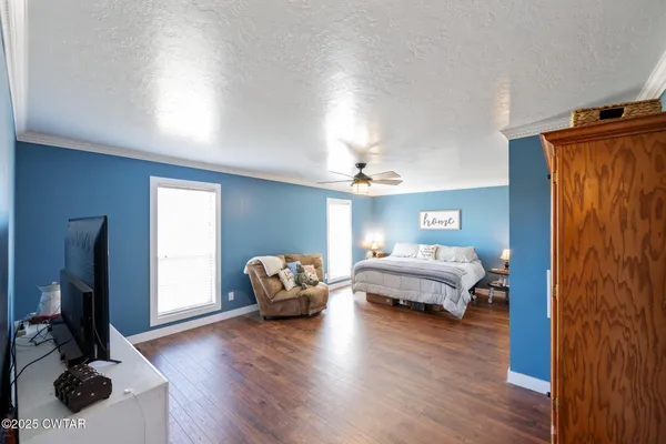 a bedroom with furniture window and wooden floor