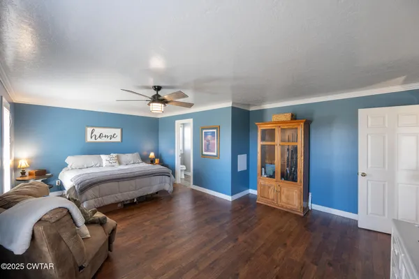 a bedroom with bed and wooden floor
