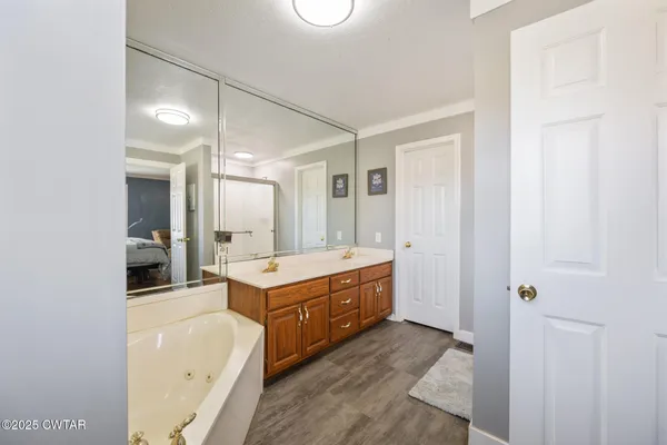 a large bathroom with a sink mirror vanity and bathtub
