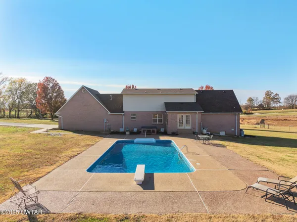 a view of a house with yard and swimming pool