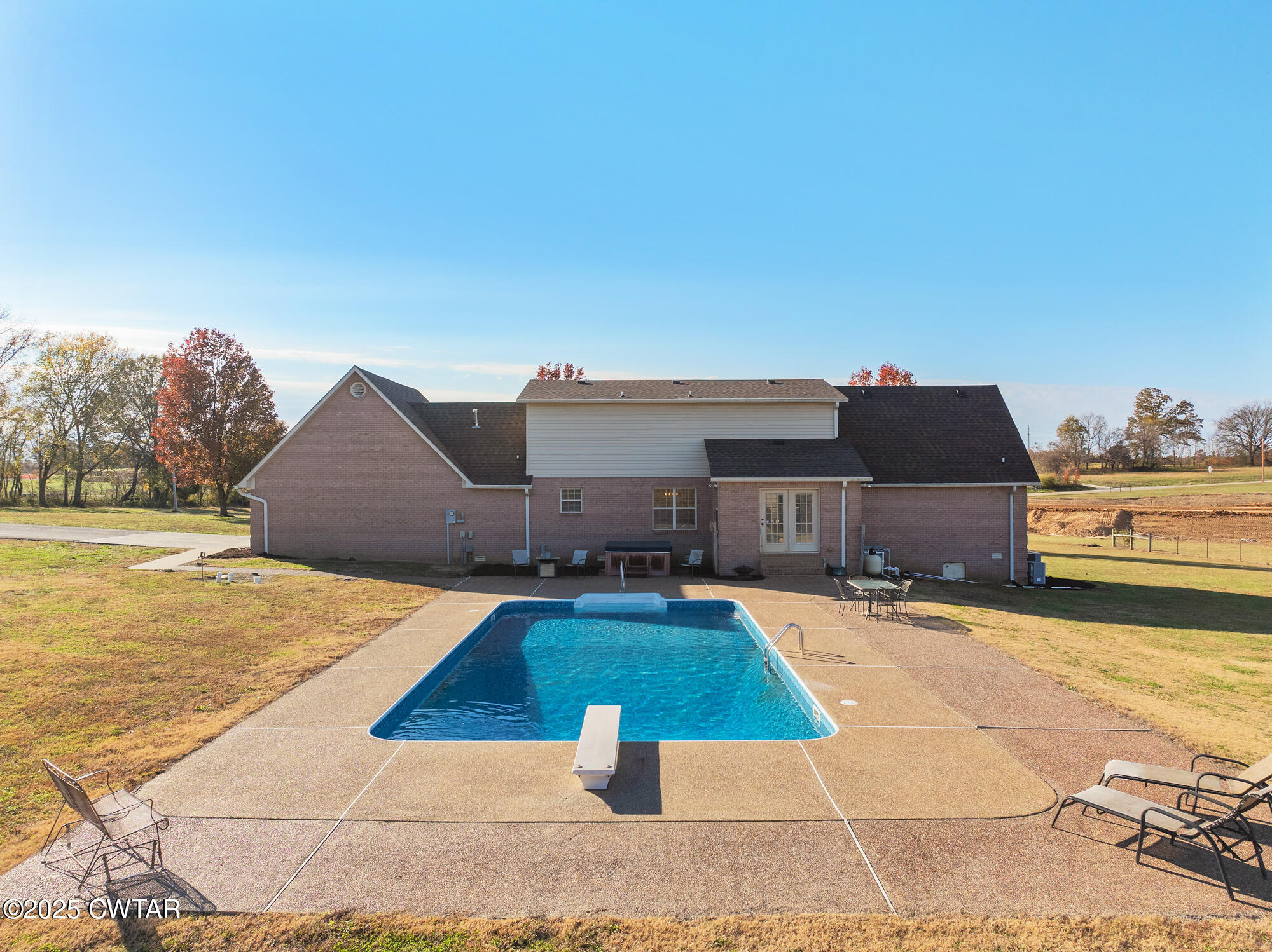 1100 Power Station Road Trezevant, TN 38258 - Photo 25 of 40 a view of a house with yard and swimming pool