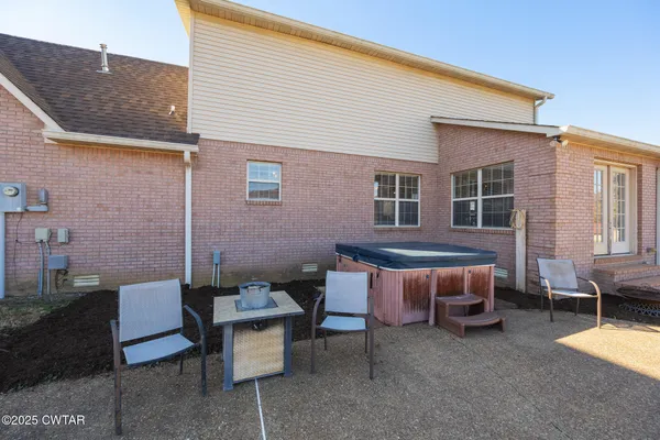 a backyard of a house with outdoor seating