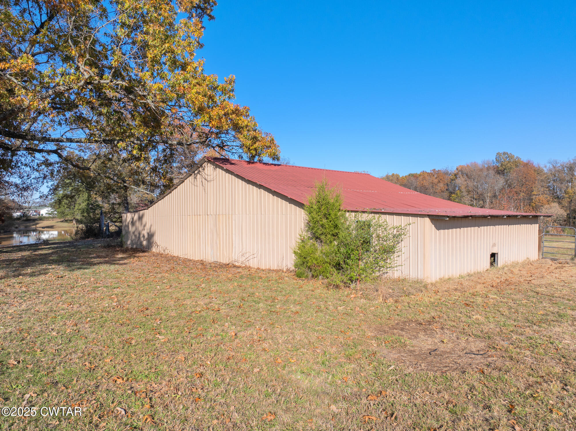 1100 Power Station Road Trezevant, TN 38258 - Photo 30 of 40 a view of a house with a yard and garage